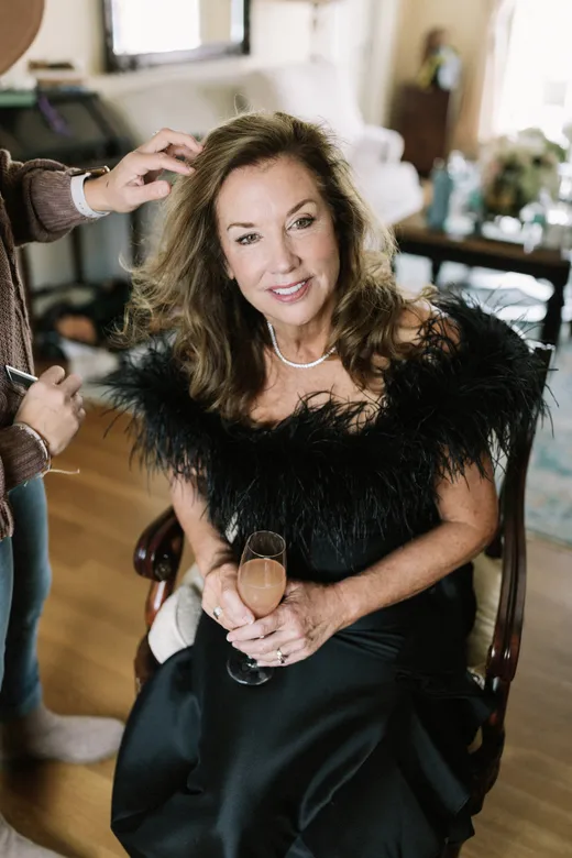 mother of the bride wears black tie feather dress