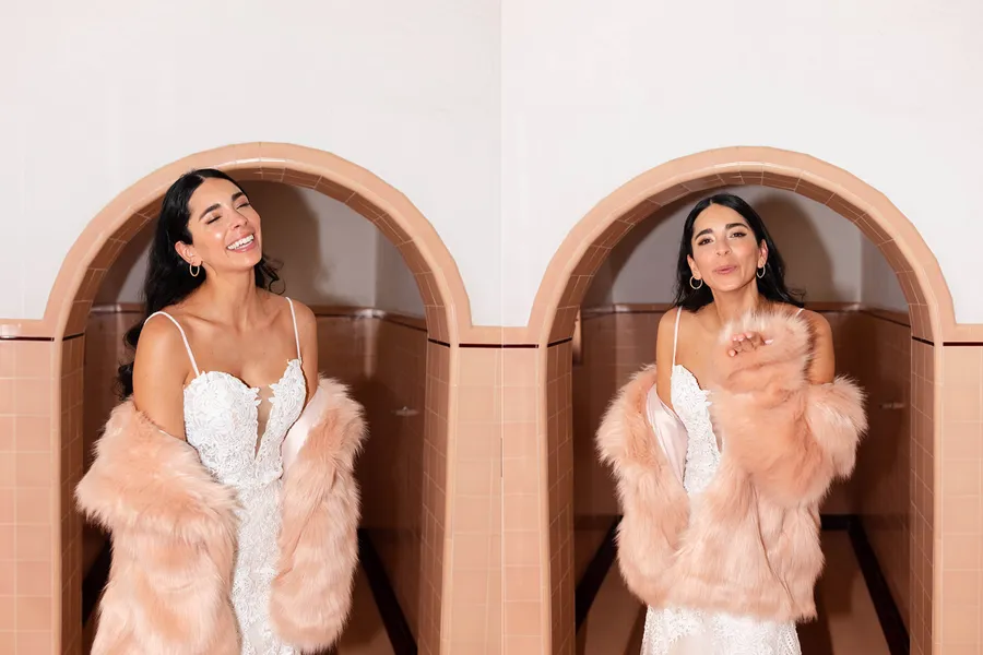 A woman in a white lace dress and pink faux fur coat smiling and blowing a kiss in front of a tiled archway, with the same woman smiling with her eyes closed and her head tilted back, also in front of the tiled archway.