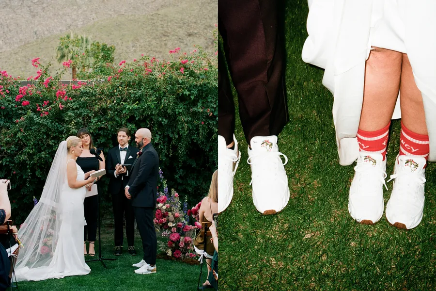 A wedding ceremony outdoors with the bride and groom exchanging vows. The bride is wearing a white wedding dress and veil, reading from a book. An officiant stands between them, holding a microphone. The background features lush green foliage and vib