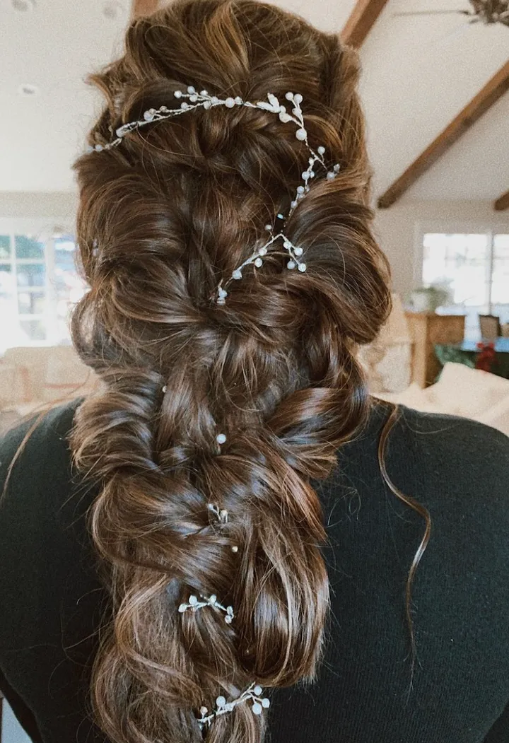 Floral bridal hairstyle, romantic hairstyle for a bride with really long hair.
