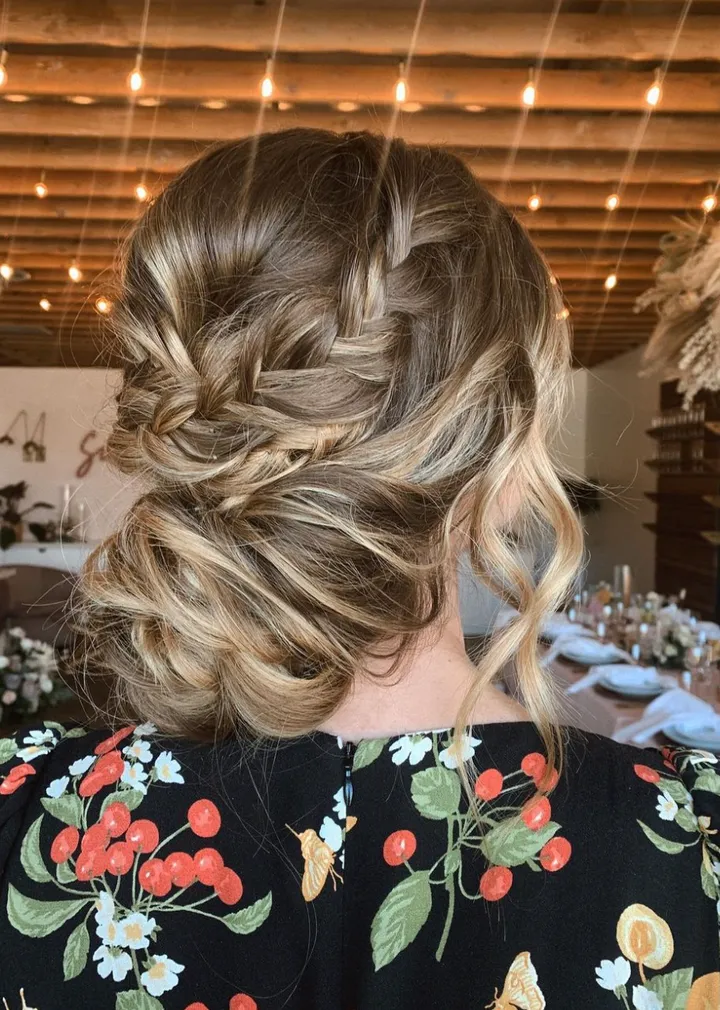 Photo of hairstyle that's loose, cascading, romantic, with braids incorporated.