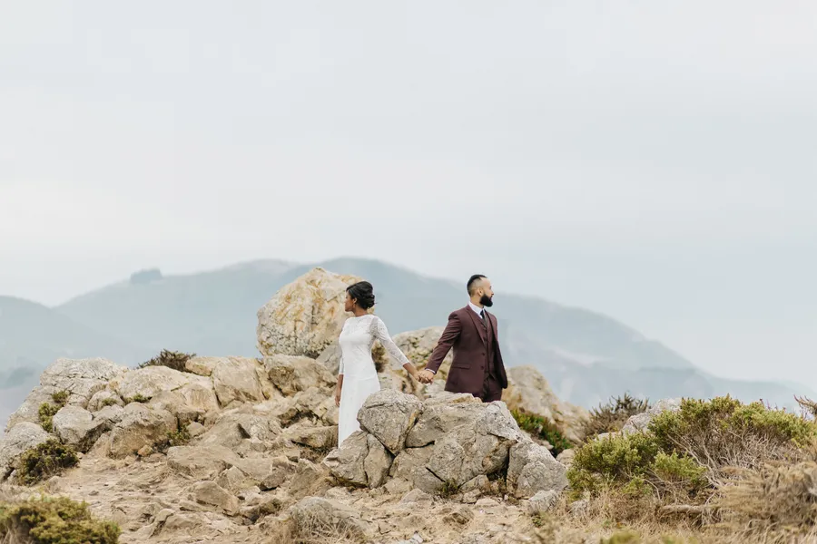 bride and groom plan their small wedding on the coastline in big sur, california