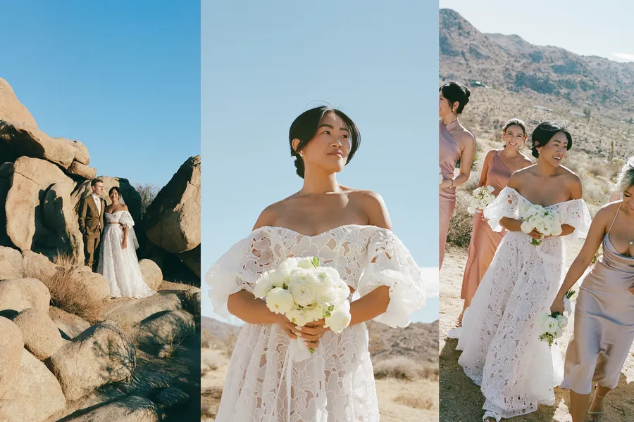A bride in a white lace off-shoulder wedding dress holding a bouquet, standing outdoors in a desert landscape with mountains in the background; a group of women, including bridesmaids in pastel dresses, walking and smiling nearby.