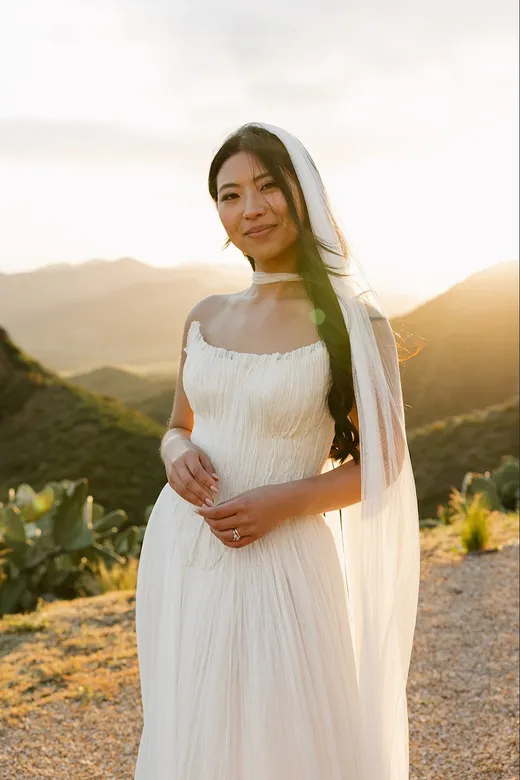 topanga canyon bride wears textured, strapless wedding gown, with gorgeous scarf and veil. Perfectly paired with natural makeup look and hair down with waves