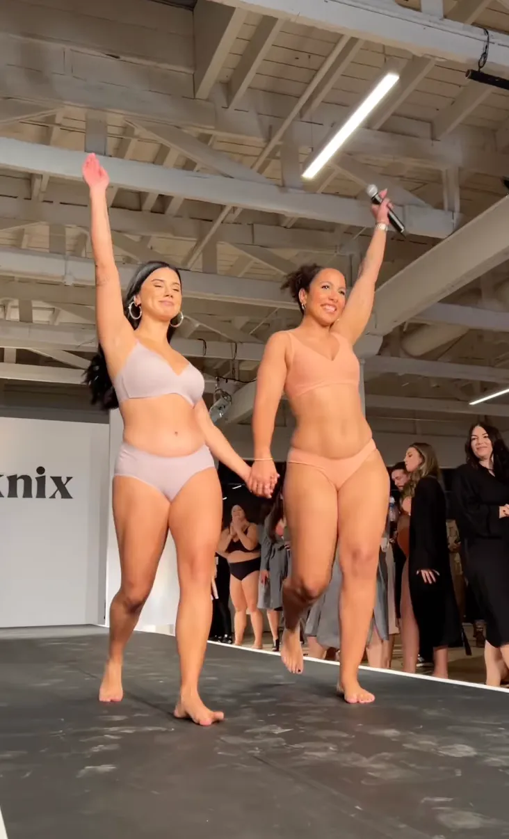 Two models on the runway at brand activation event in los angeles. Hair and makeup for the models looks natural and is all about women empowerment.