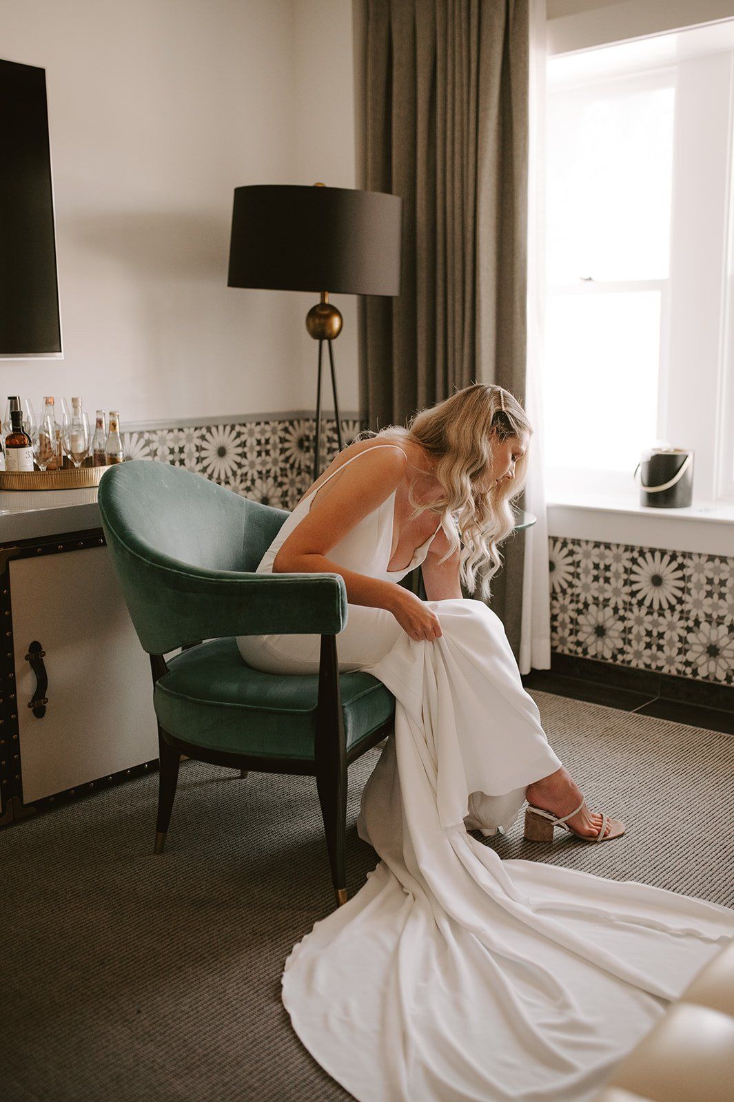 bride puts on her wedding shoes before her santa barbara wedding ceremony