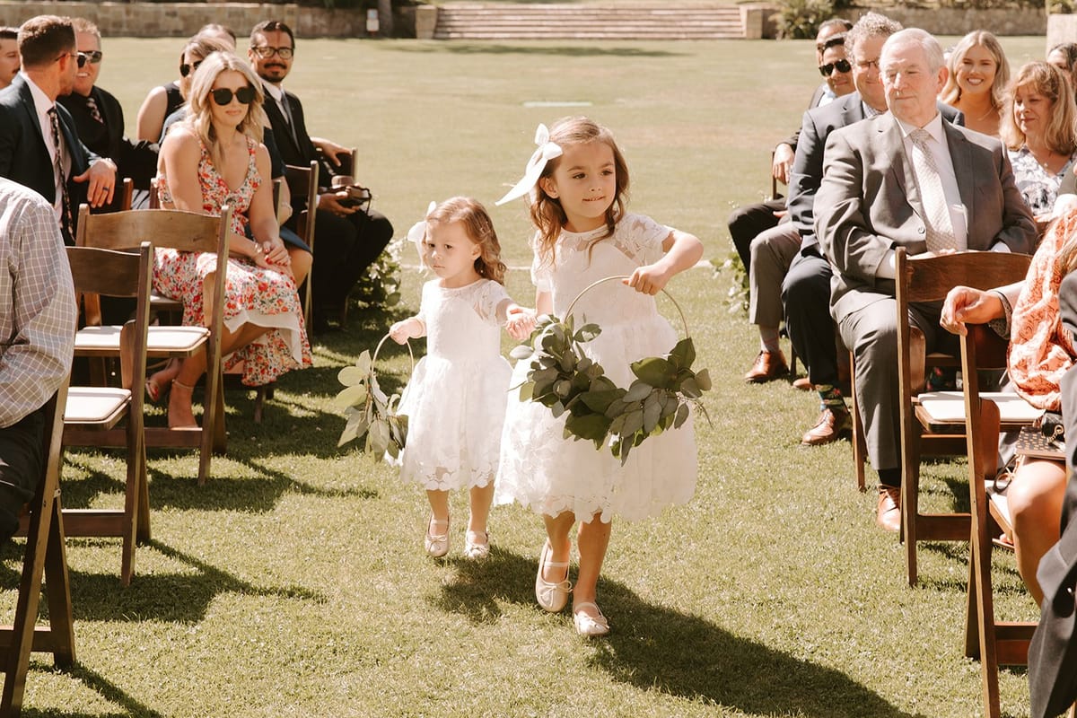 flower girls walk down the aisle
