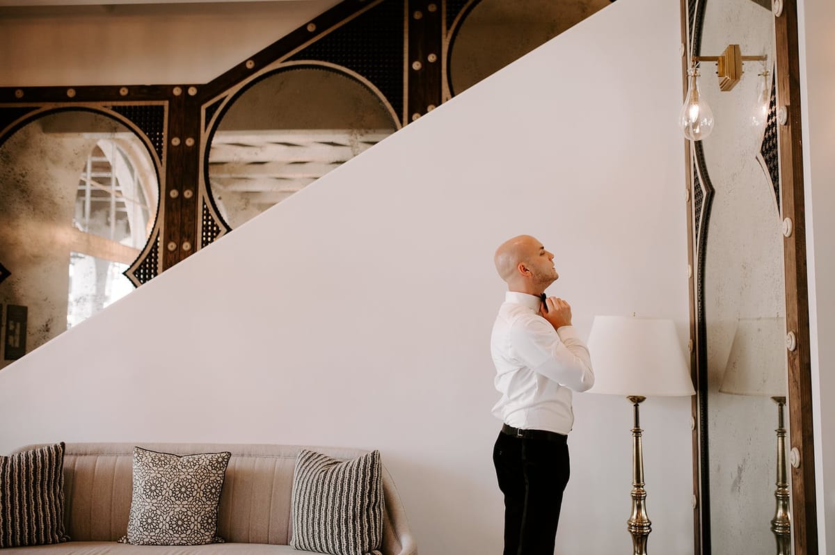 groom gets ready for his first look on his wedding day