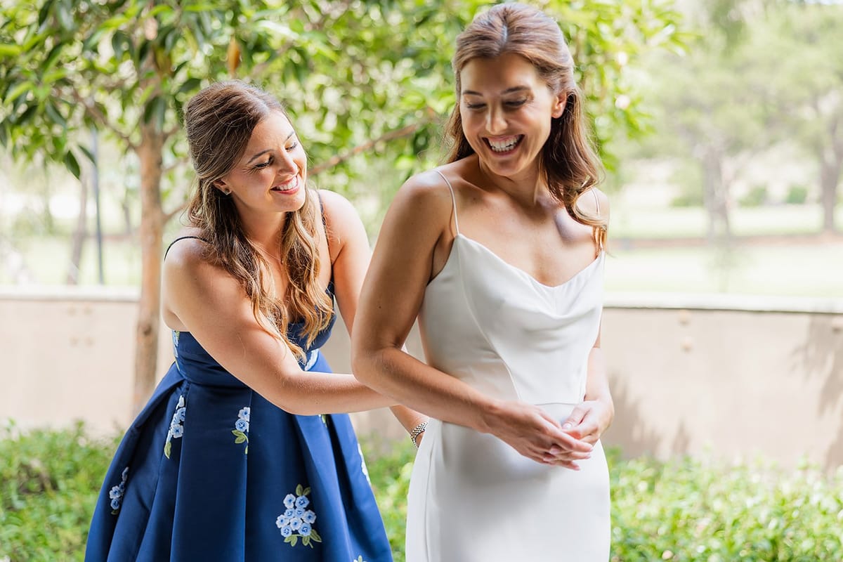bride and her sister get ready for laguna beach wedding