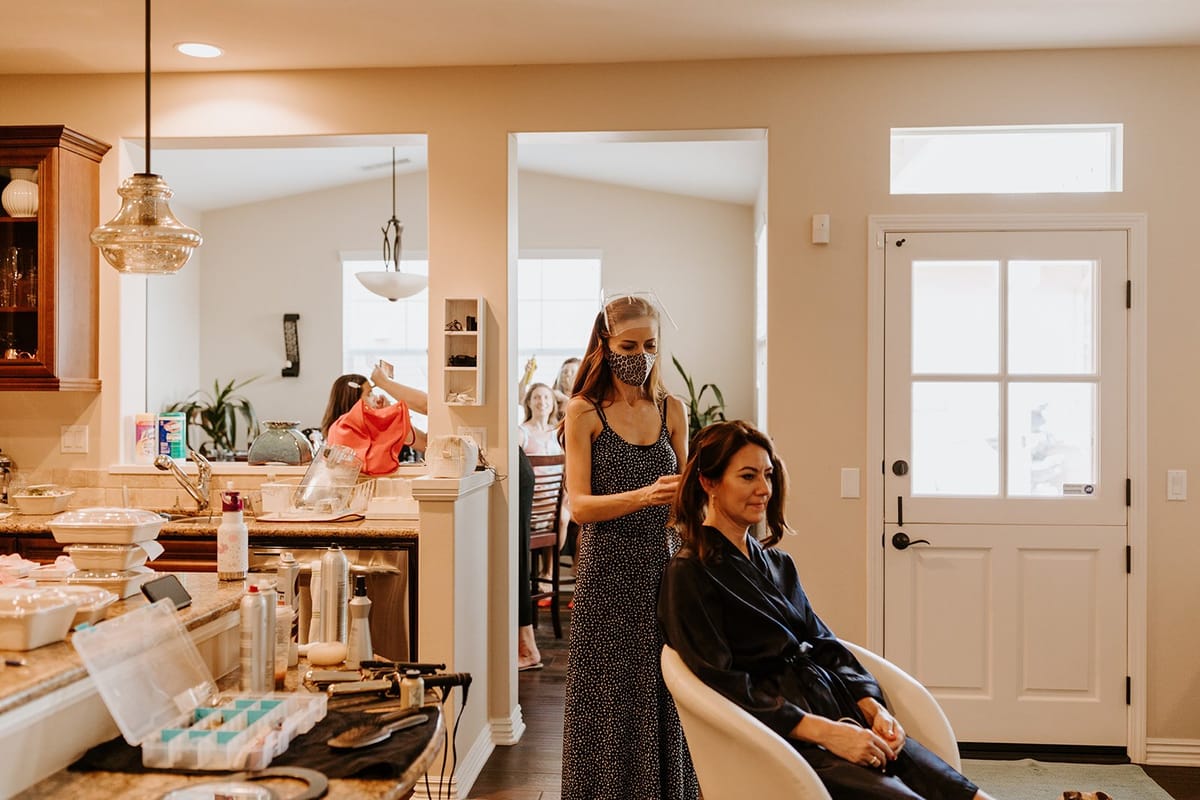 hair stylist working during covid 19 pandemic for micro wedding