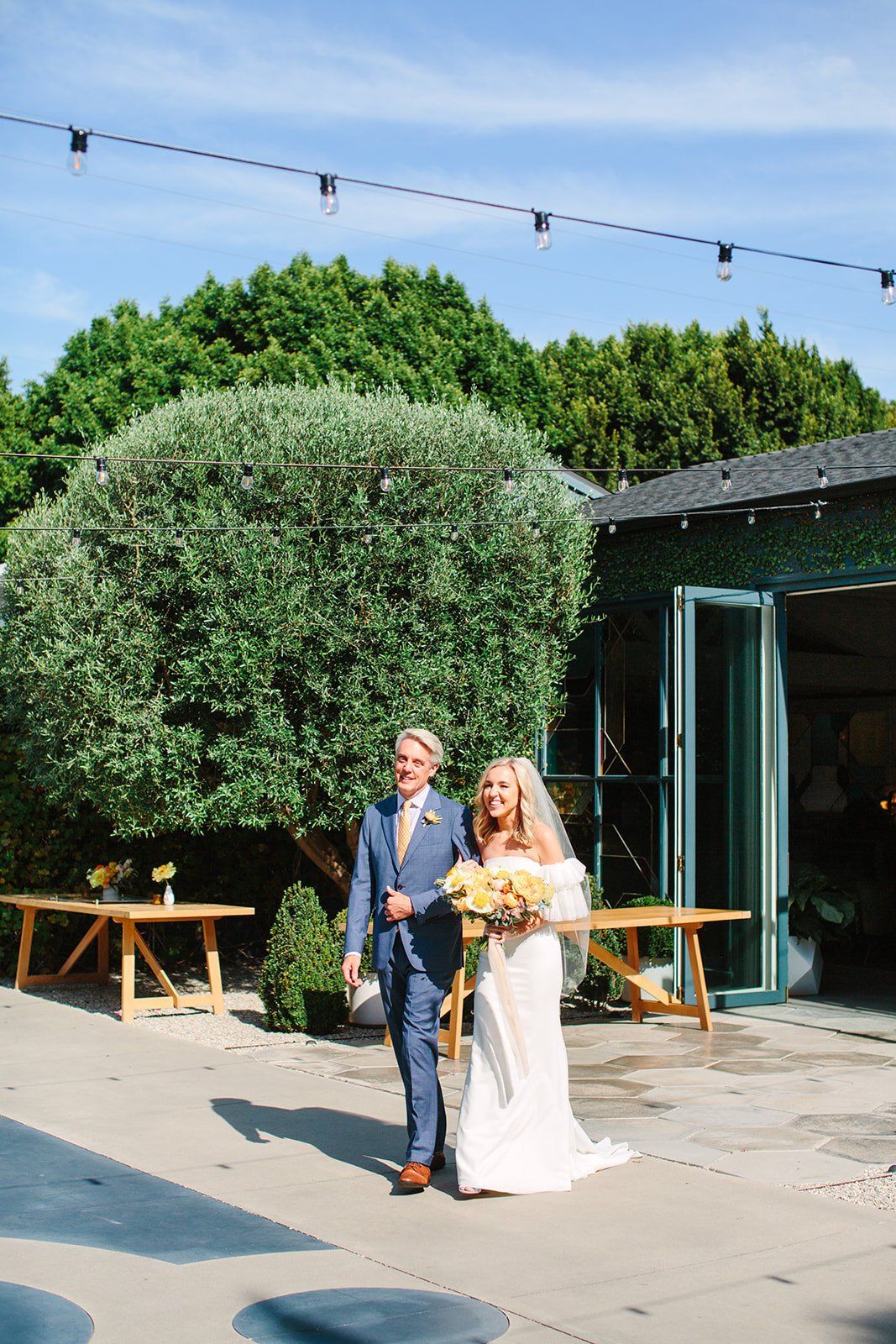 gorgeous bride walks down the isle with her dad