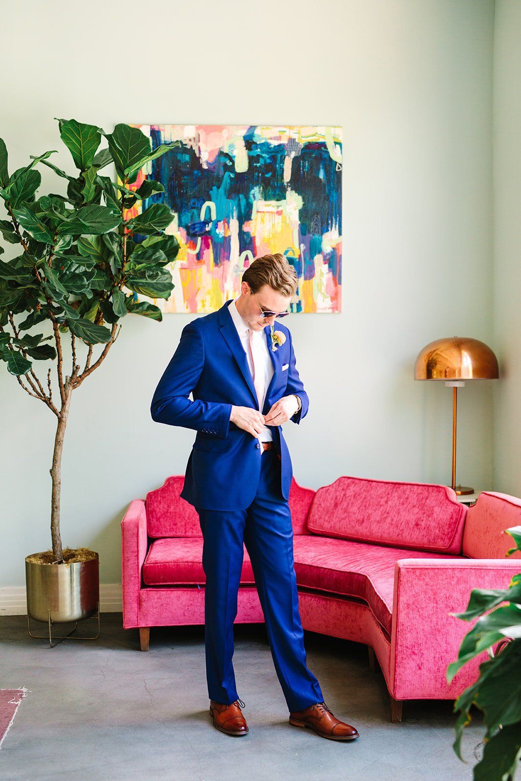 groom gets dressed for his destination wedding in highland park