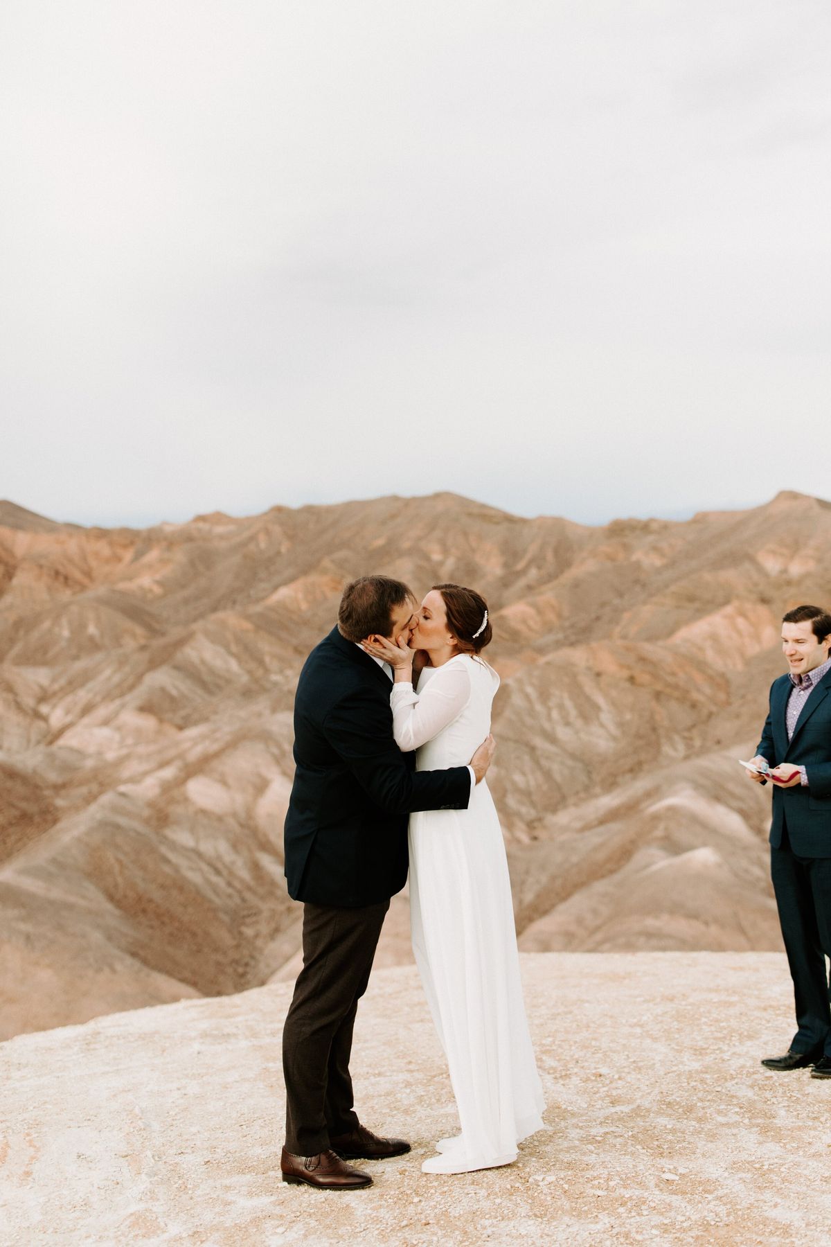 husband and wife share their first kiss after wedding ceremony at death valley national park