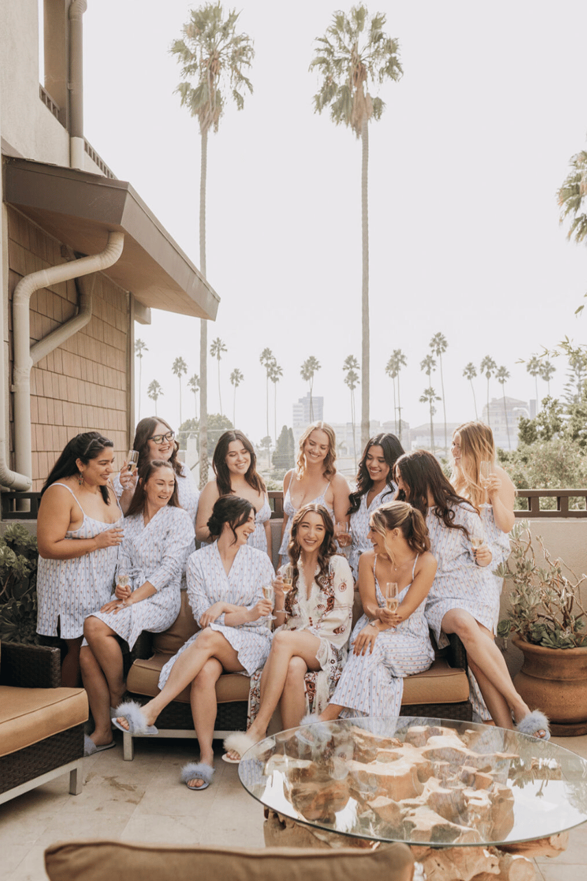 bride and bridesmaids in malibu enjoying a sunny morning outside after hair and makeup