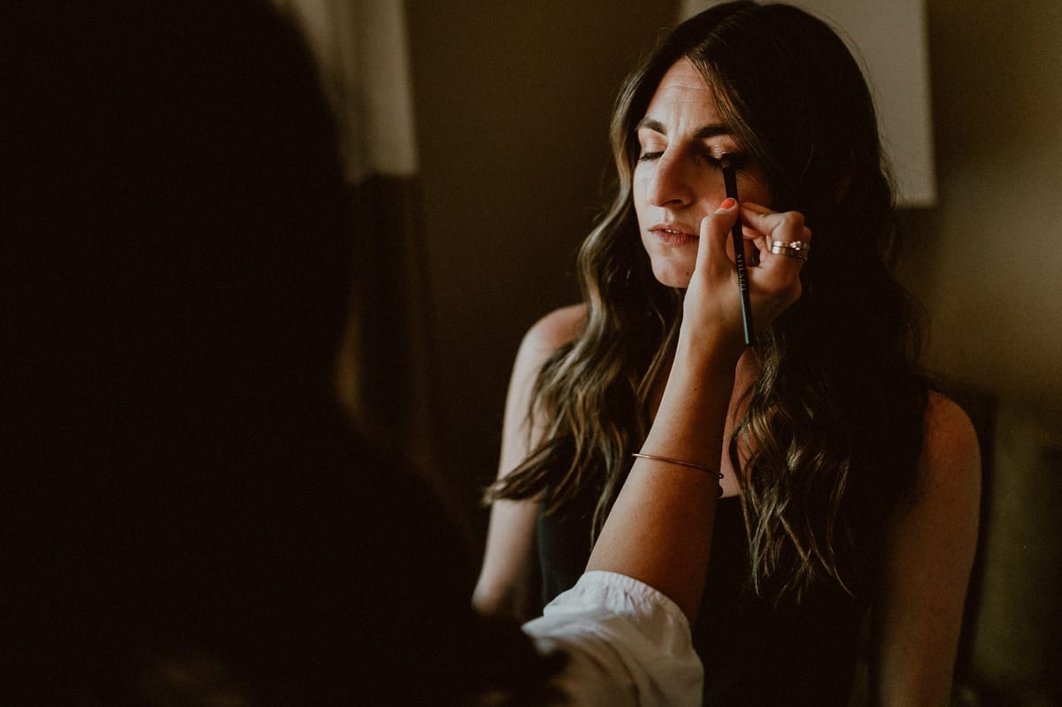 alisal ranch bride gets hair and makeup touch ups before her ceremony