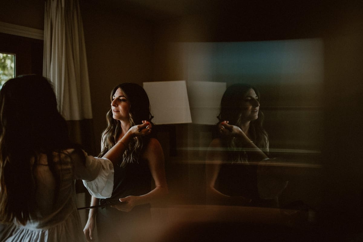 bride getting makeup done on the morning of her wedding