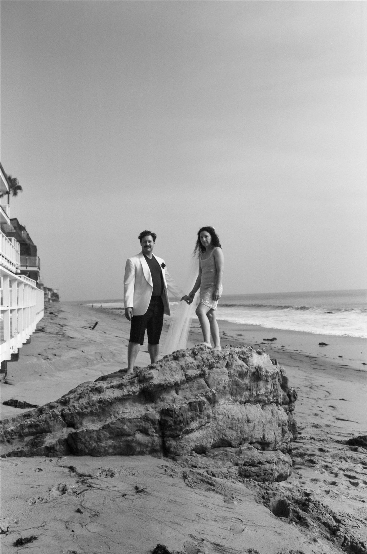 bride and groom walk oceanside in malibu during their LA destination elopement