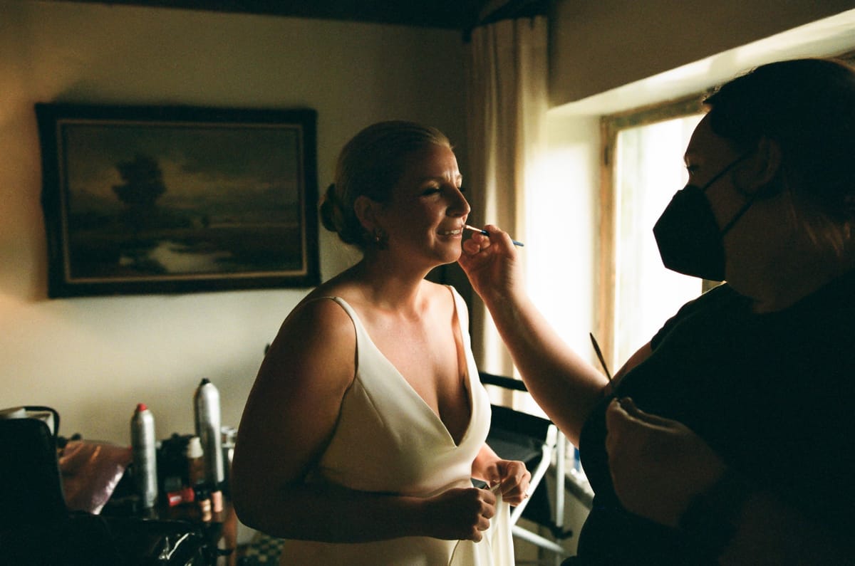 bride getting hair and makeup touch ups before her palm springs wedding