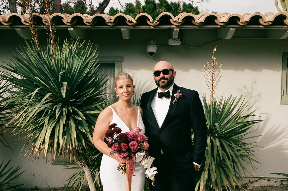 bride and groom pose outdoors before their dream palm springs wedding
