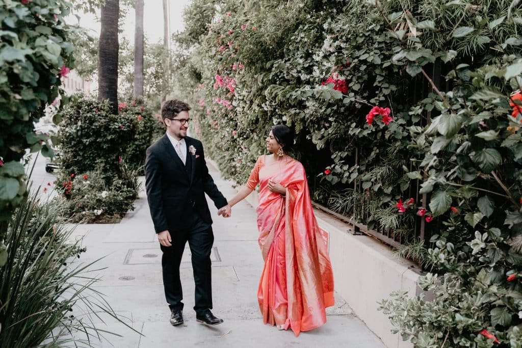 bride and groom take wedding photos after los angeles rooftop wedding at the line hotel