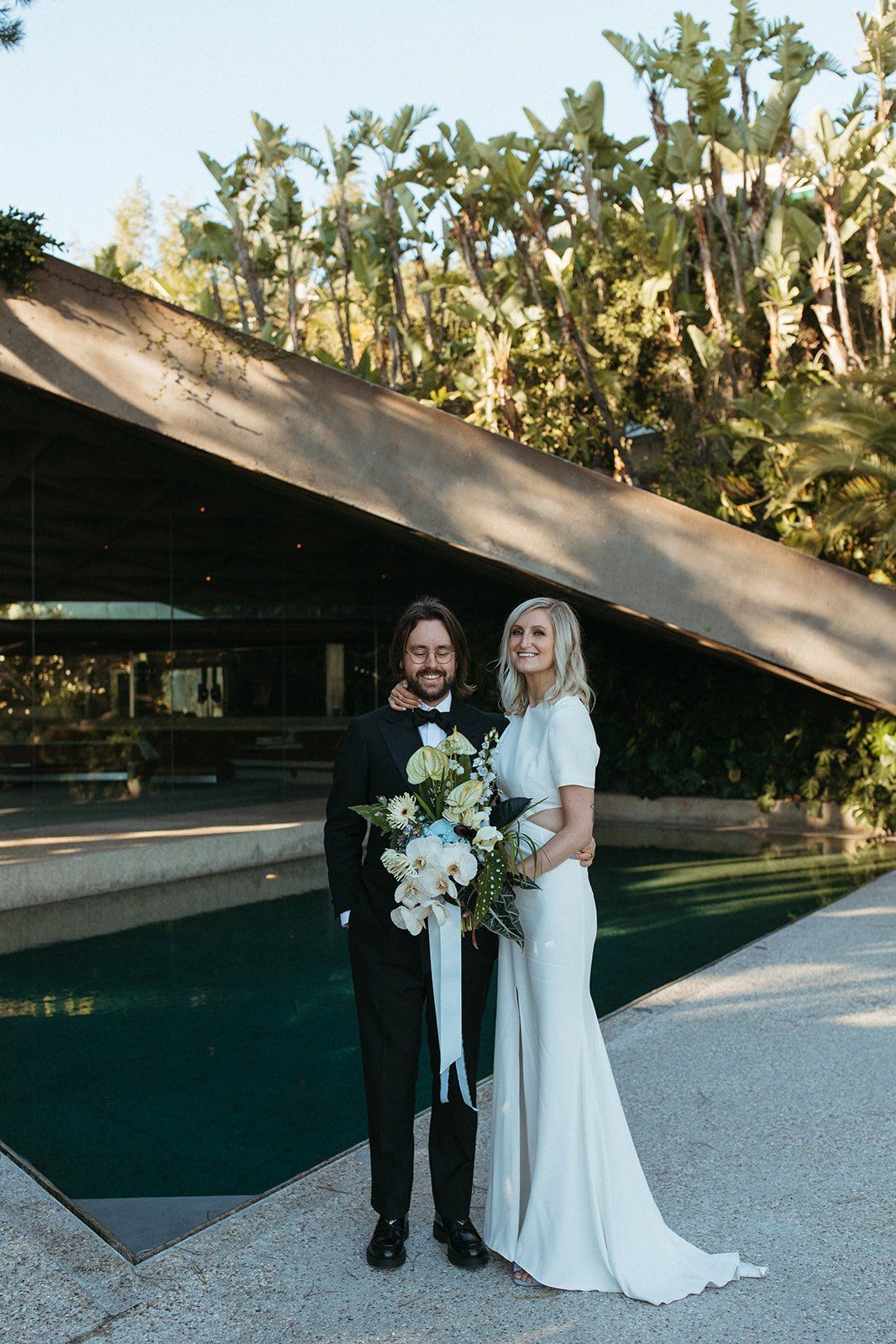 bride and groom take wedding photos at their destination venue, the Sheats–Goldstein Residence in beverly hills