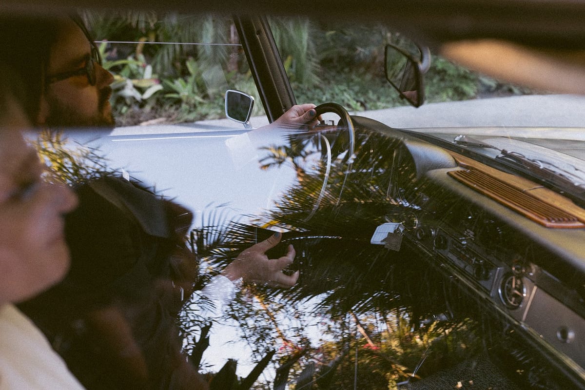 bride and groom drive off in vintage convertible after their elopement in LA