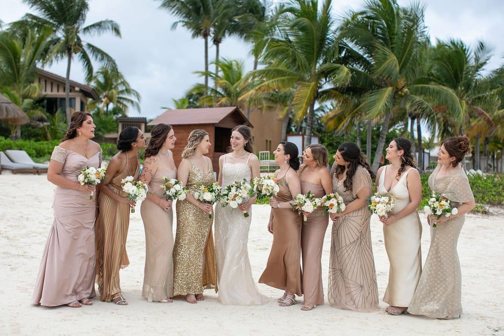 bridal party dressed in blush, neutrals, and gold for mexico destination wedding