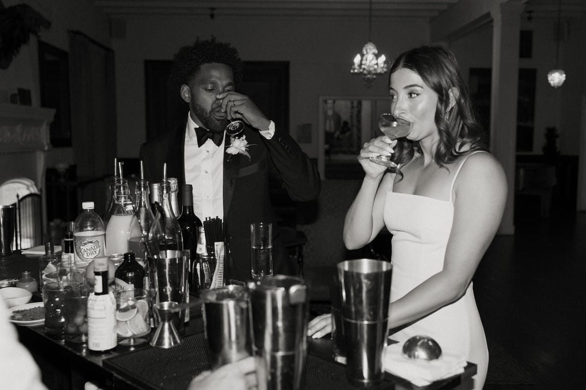 bride and groom sip signature cocktails at their wedding reception