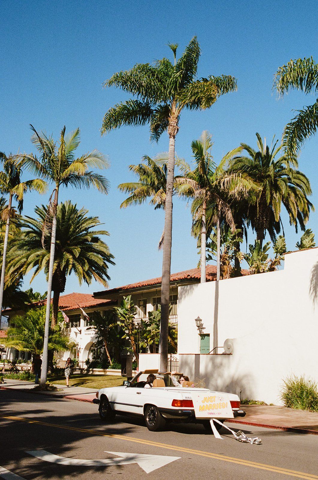 brides' drive off in their vintage convertible after their california wedding ceremony