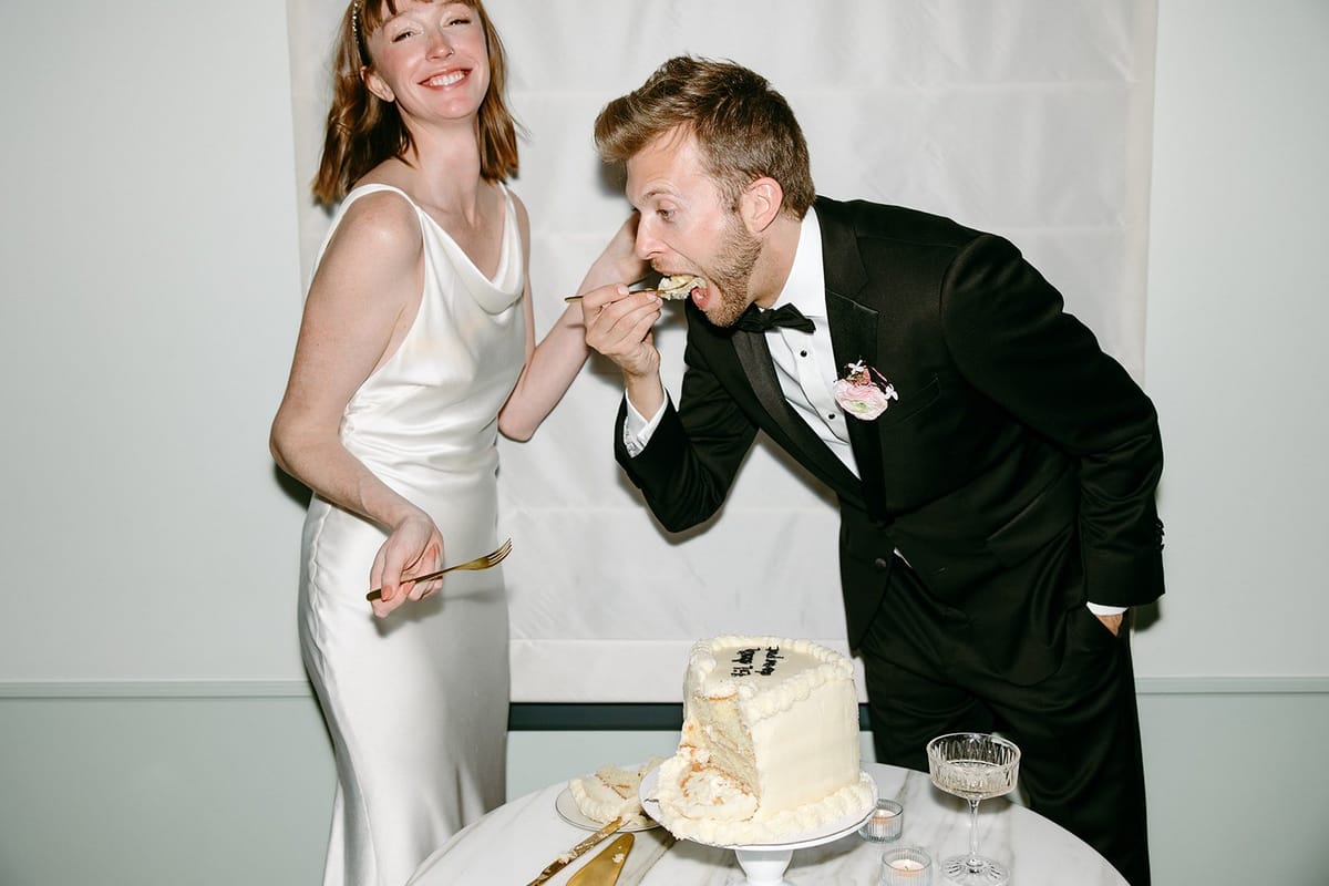 bride and groom's wedding cake reads: "til death due us part"