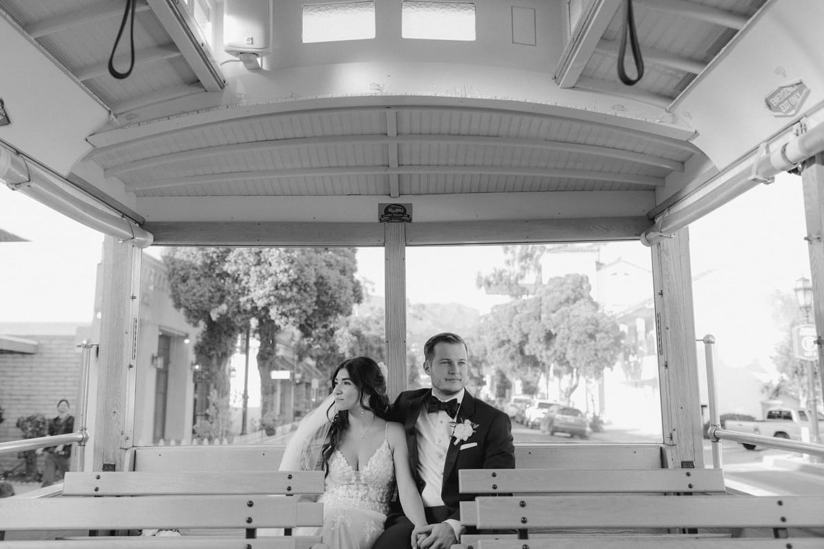 bride and groom ride the trolley around santa barbara on their wedding day