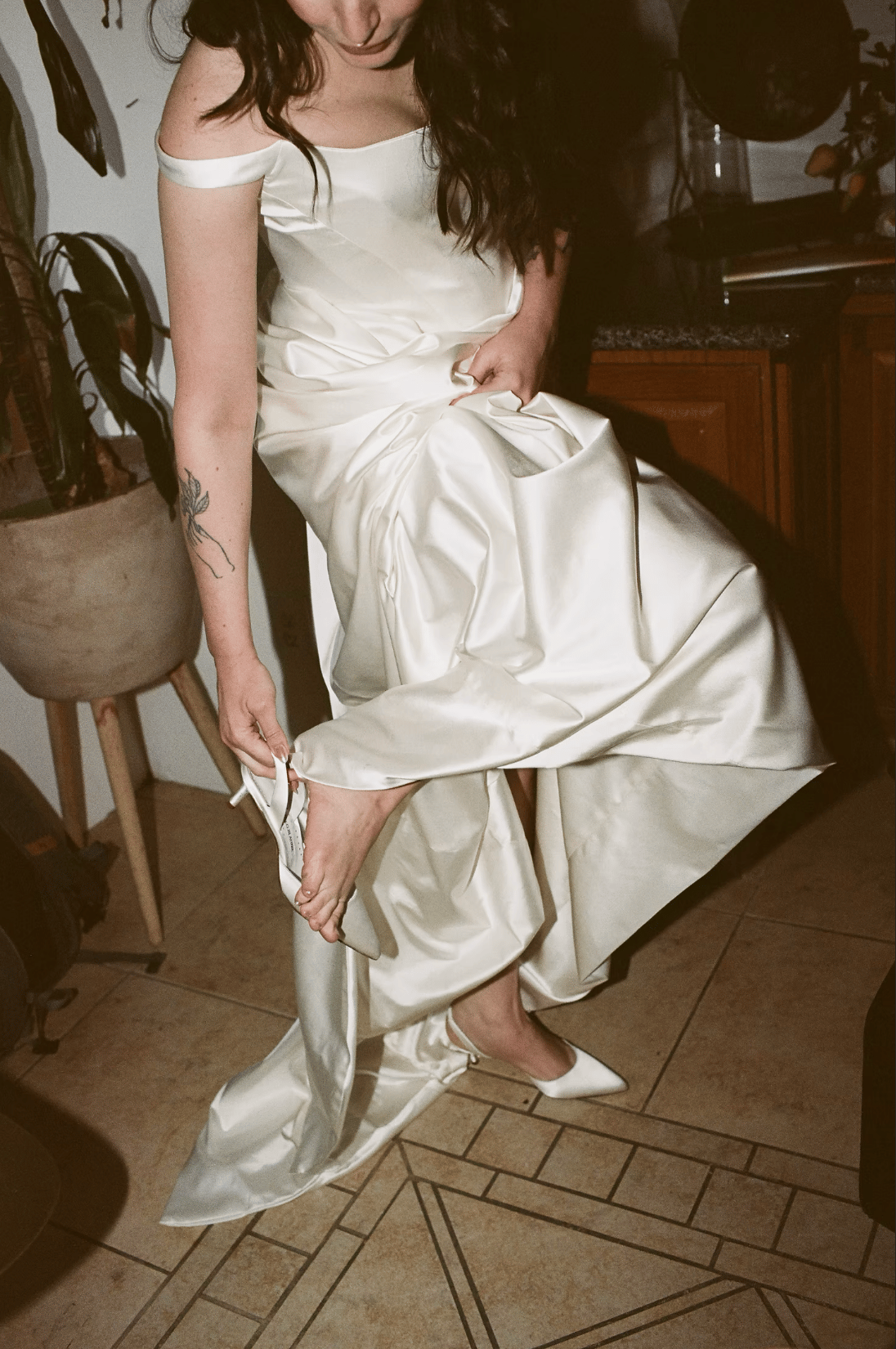 bride getting dressed before her temecula wedding