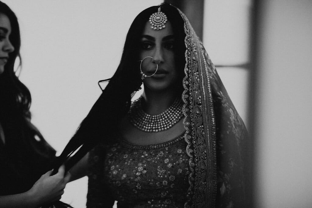 indian bride's big loose curls and dramatic makeup look