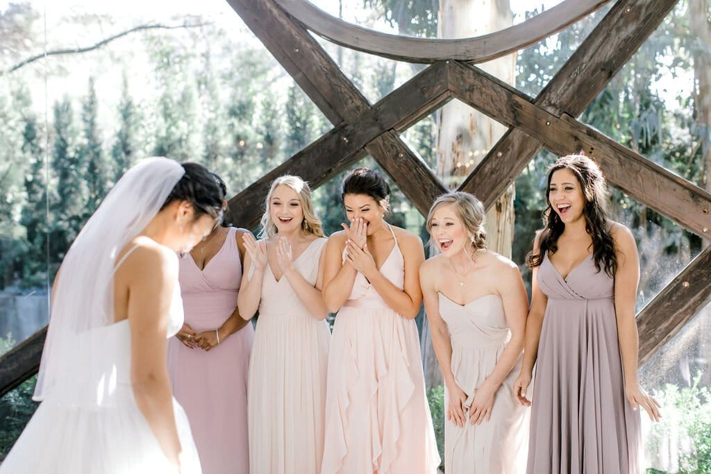 classic bride and her bridal party have an adorable first look moment after getting glammed