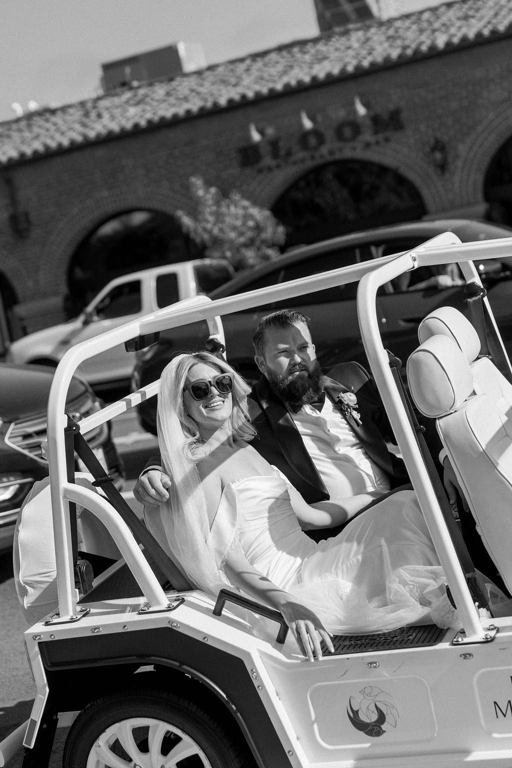 Bride and groom drive off in cute moke style golf cart after being pronounced husband and wife