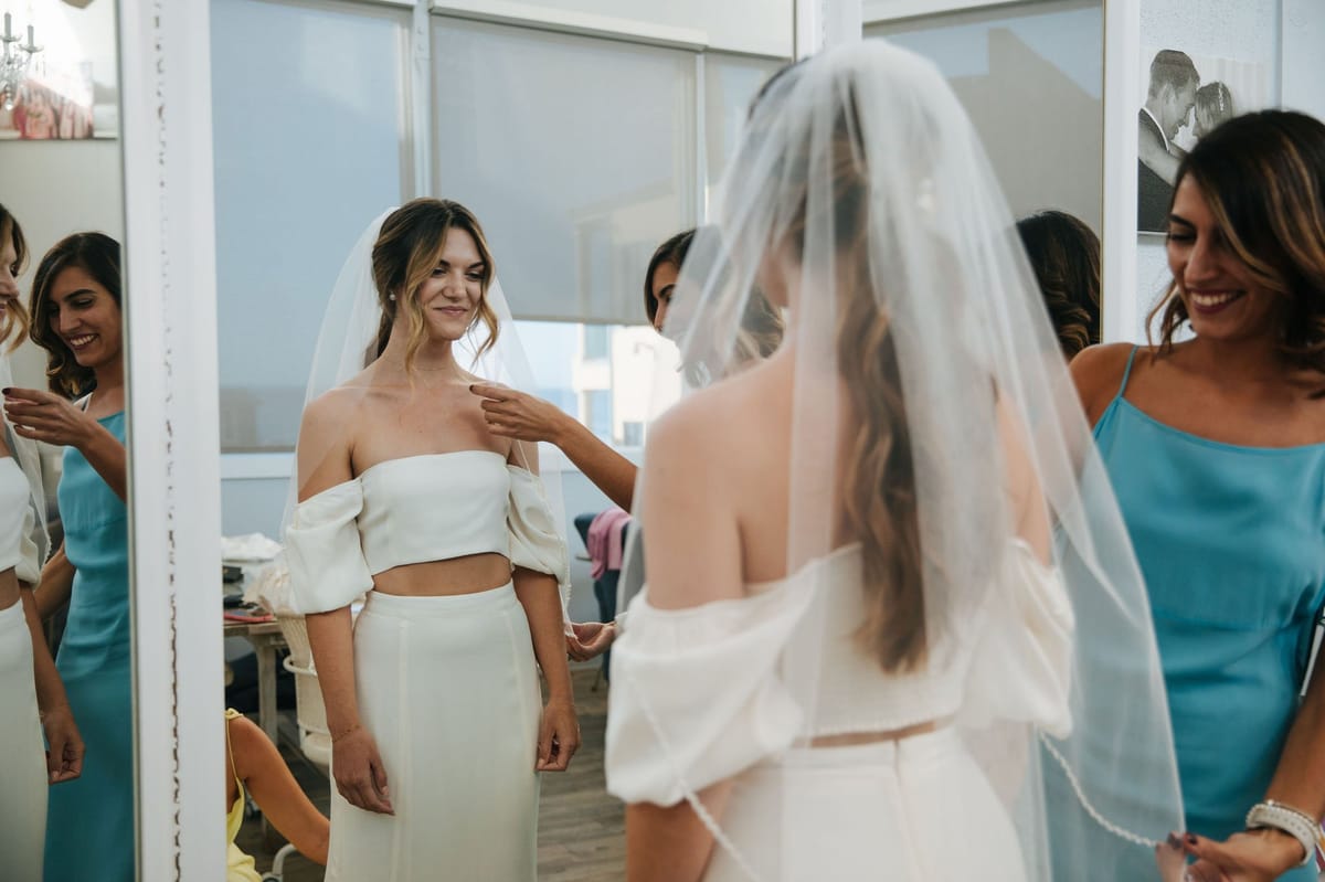 bride choose a wedding day ponytail look and natural airbrush makeup for her wedding along the socal coast in malibu