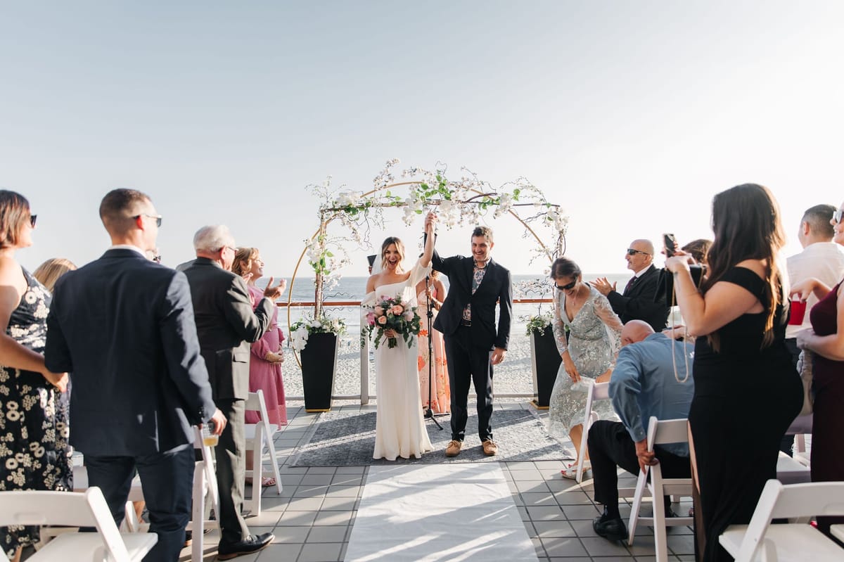 summer wedding in malibu along the coast at sunset