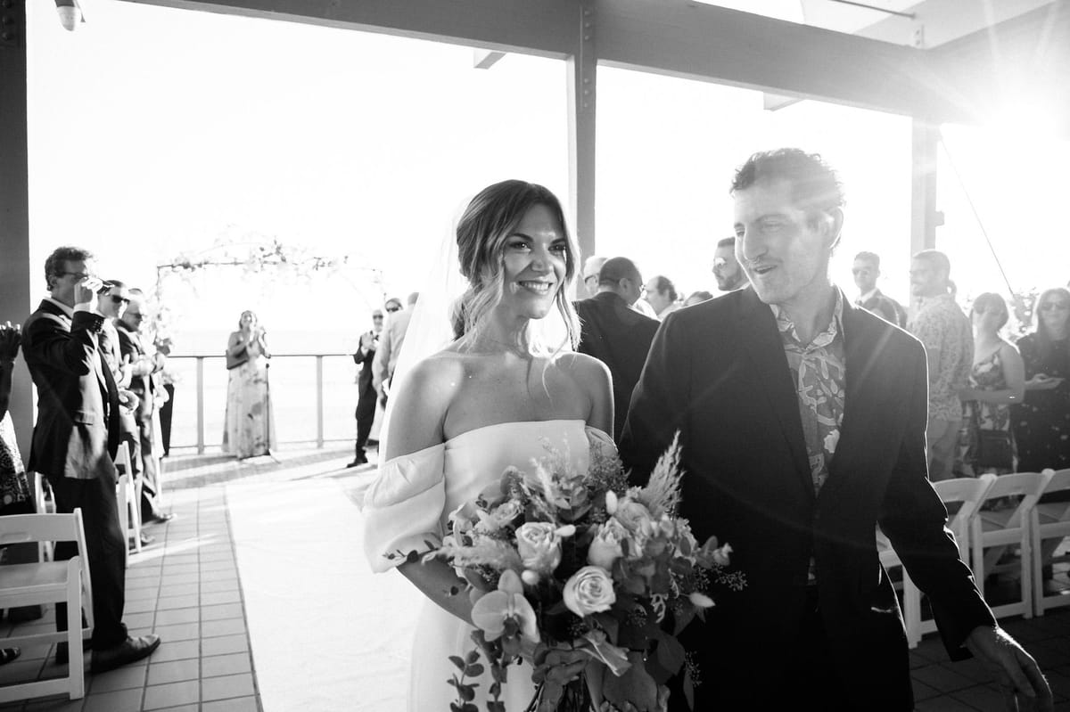 bride and groom walk down the aisle together after their wedding ceremony