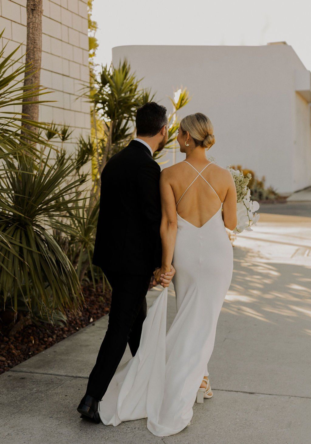 hailey bieber's slicked back low bun hairstyle is the perfect wedding day hair moment