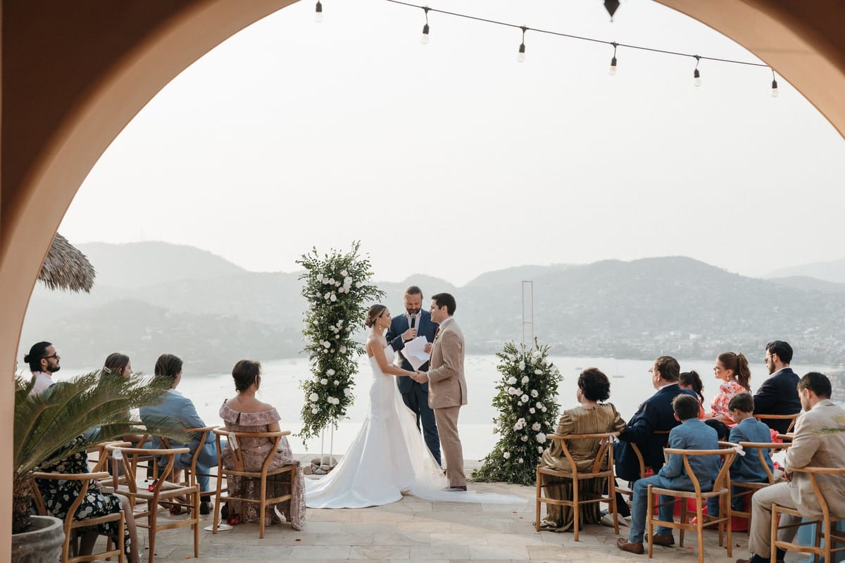 destination wedding in the bride and groom pose for wedding day film portraits after their destination wedding ceremony in the Zihuatanejo bay, in mexico