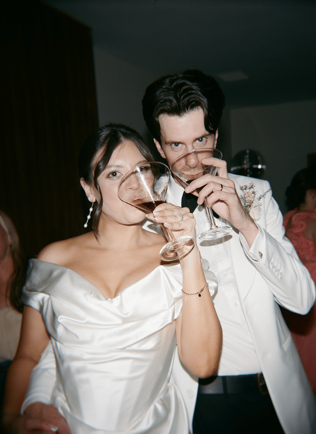 modern flash photo of bride and groom at their palm springs wedding reception drinking espresso martinis
