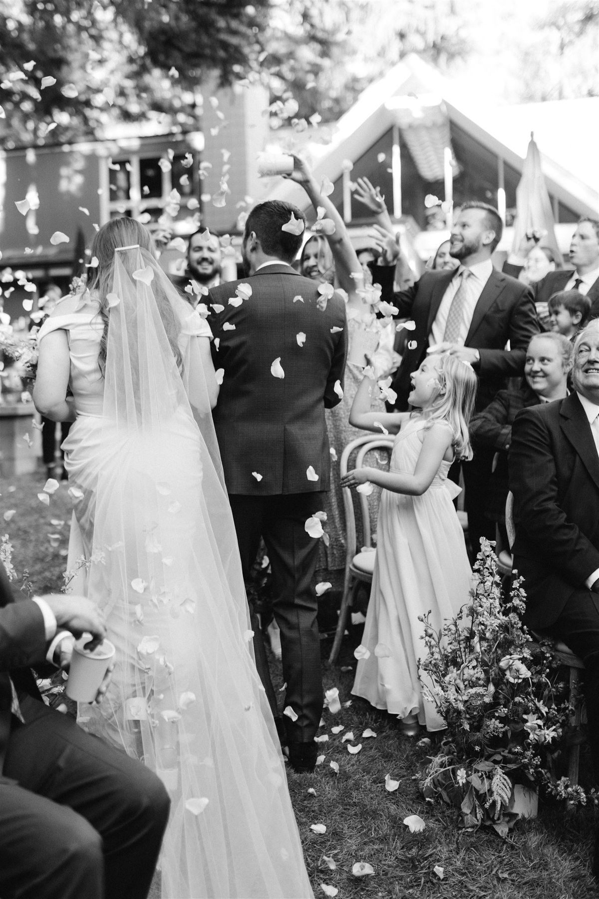 newly married couple with rose petal exit