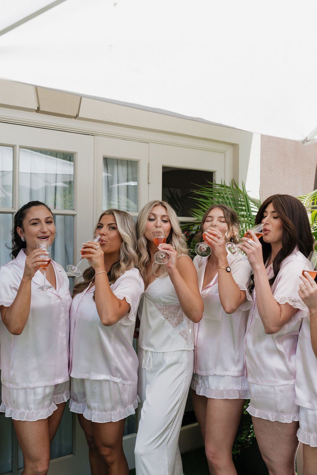 bride and her bridesmaids all finished with wedding day hair and makeup, enjoying champagne at the four seasons