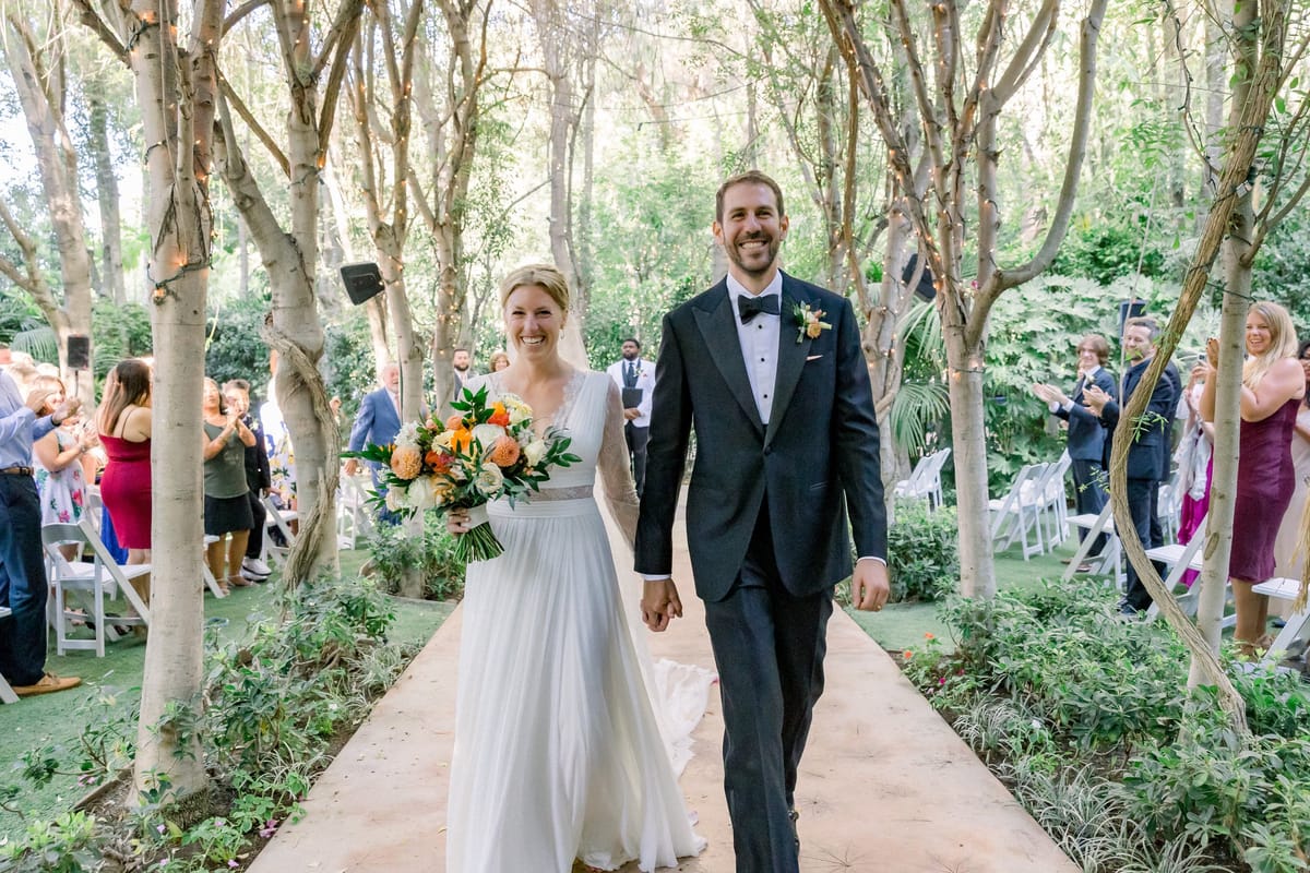 LA hair and makeup team provides natural makeup and braided and boho hairstyle for bride and her bridal party for socal wedding